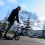 Erste E-Scooter-Anbieter in Hamburg gestartet Mann fährt auf einem E-Scooter.