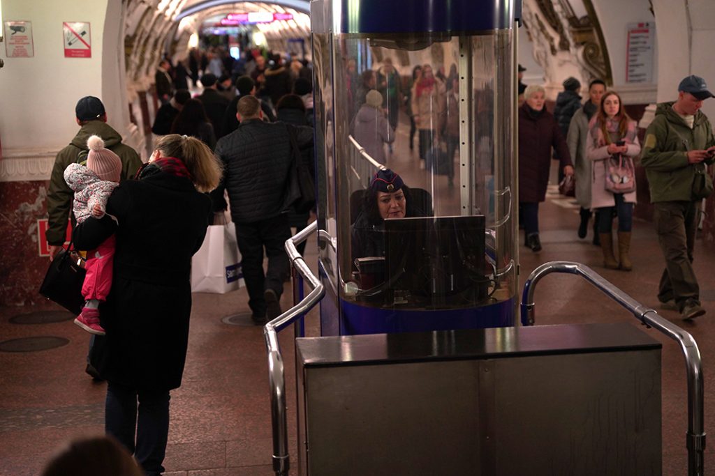 Rosalia Aleeva sits at the bottom of the escalator in a booth. 