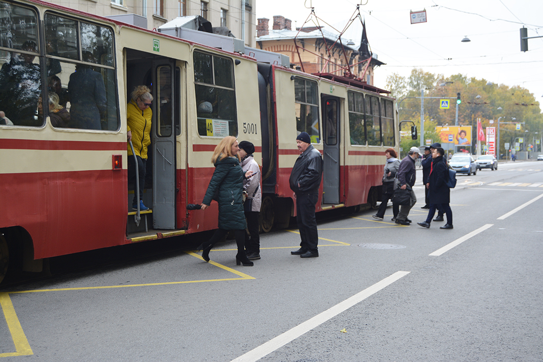 On a street in Saint Petersburg a tram stops for the passengers who want to step out of the tram or get on it.