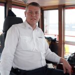 What’s your job in transportation? – Ferry skipper Alexander Krämer sits in the wheelhouse of a ferry in the port of Hamburg