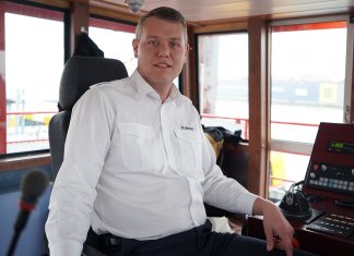 What’s your job in transportation? – Ferry skipper Alexander Krämer sits in the wheelhouse of a ferry in the port of Hamburg