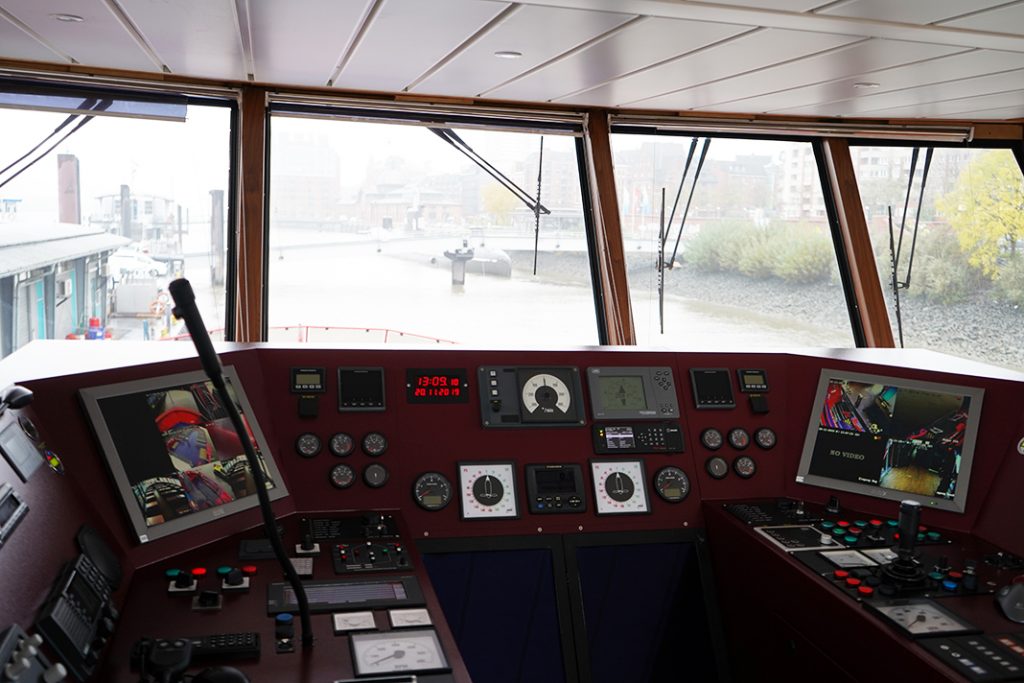 There are a lot buttons and screens in the wheelhouse of a ferry.