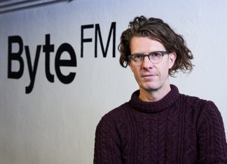 “Es braucht in Zukunft nicht mehr 100 Sender, die alle gleich klingen” Ruben Jonas Schnell vor dem ByteFM-Logo.