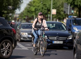 Fahrrad fahren in Hamburg: Ein Königreich für ein Auto Fahrrad fahren in Hamburg: Eine Radfahrerin fährt zwischen vielen Autos