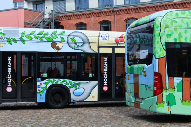 Nahaufnahme der zwei bemalten Busse.