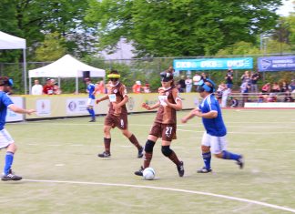 Wenn Stille den Weg zum Tor ebnet Vier Spieler*innen beim Blindenfußball auf dem Feld.