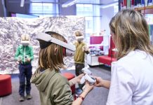 Kreativ Technik und KI entdecken Ein Kind hat eine Virtual-Reality-Brille auf dem Kopf und einen Controller in der Hand. Grund dafür ist die Auftaktveranstaltung der Code Week Hamburg in der Hamburger Bücherhalle.