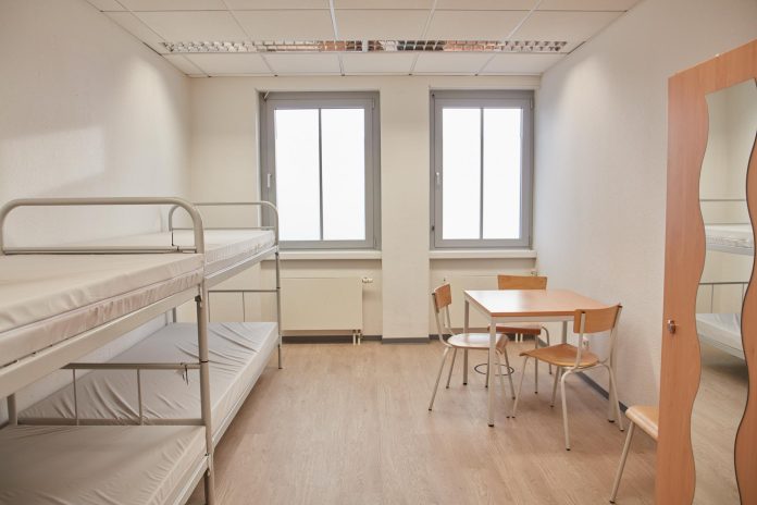 Olympia Text BildNeuland Concerts Copiright-5 So sieht ein noch unbenutztes Zimmer in einer der Einrichtungen von Fördern und Wohnen aus. In diesem Zimmer stehen 4 Betten, ein Tisch mit Stühlen und Stauraum. Symbolbild: Hamburger Winternotprogramm