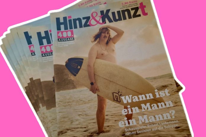 400 mal Hinz & Kunzt Eine Abbildung von der 400. Ausgabe von Hinz & Kunzt. Auf dem Cover ist Schauspieler Robert Lindemann zu sehen wie er an einem Strand ein Surfbrett trägt.