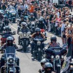 Harley Days in Hamburg: Sperren wegen Motorradparade erwartet Viele Motorradfahrer*innen fahren in Reihen über eine Straße in der Sonne.