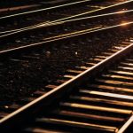 Nach mutmaßlichem Brandanschlag: Zugverkehr läuft wieder Gleise im Gegenlicht. Schotteroberbau mit Holzschwellen.